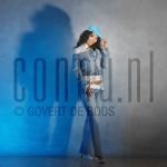 31-03-2004 Hind at studio in Amsterdam, by order of Glossy Magazine. March 31, 2004.

[keywords]Posed, Full Length, Cap, Smiling[/keywords]